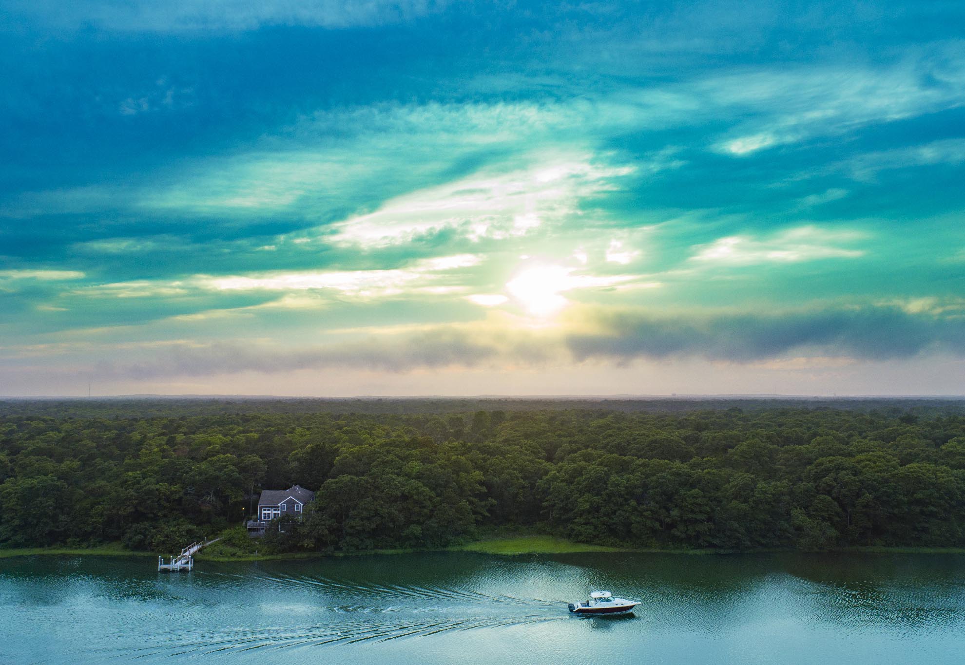 Drone Photograph of Boat going up inlet in East Falmouth at Sunset