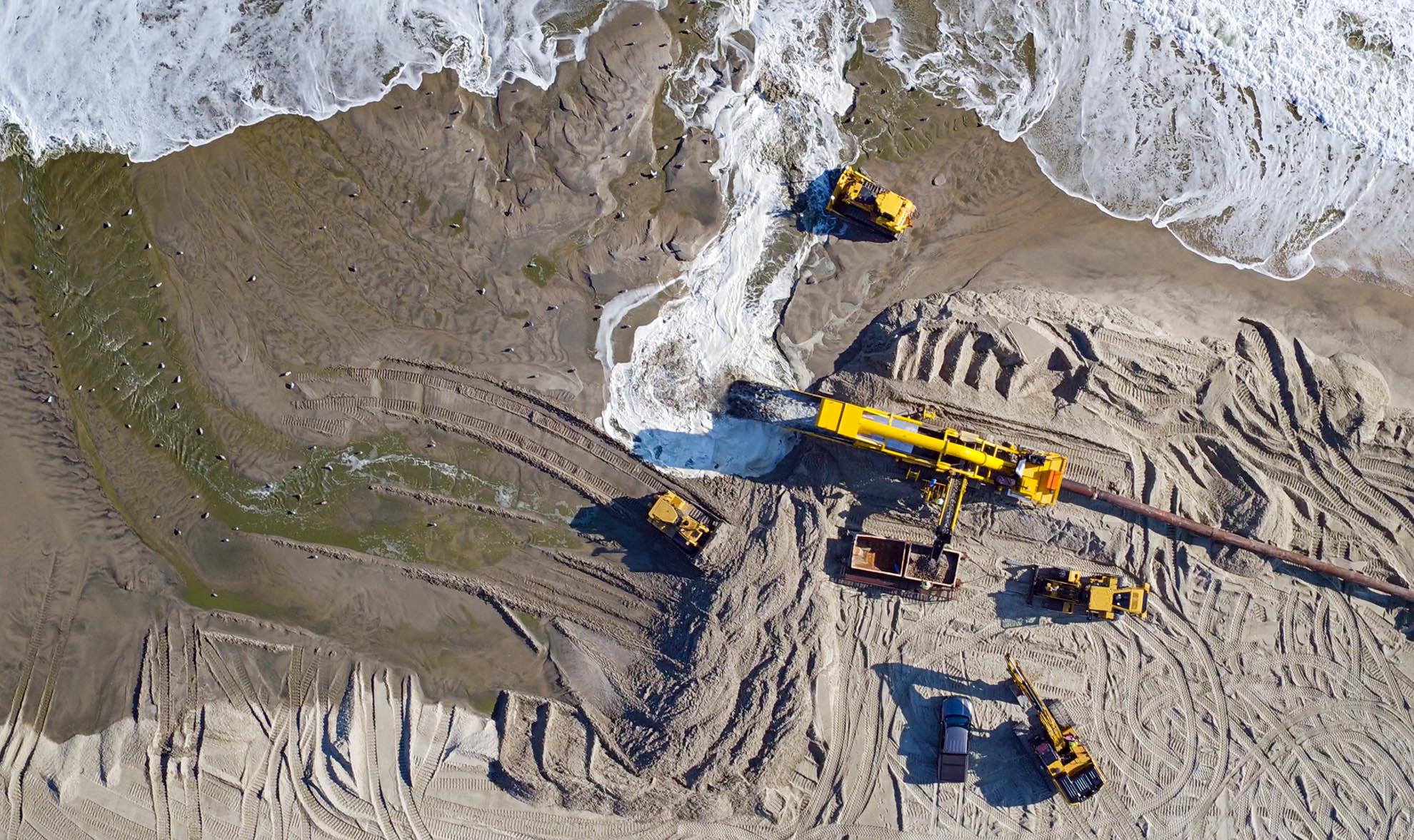 Drone Photograph of birds eye view of Excavating equipment Rebuilding Beach on the New Jersey Shore