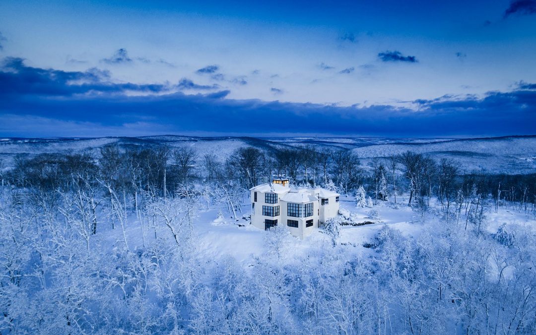 Drone Photograph of white Modern Home on Mountain Top after snow storm in NJ