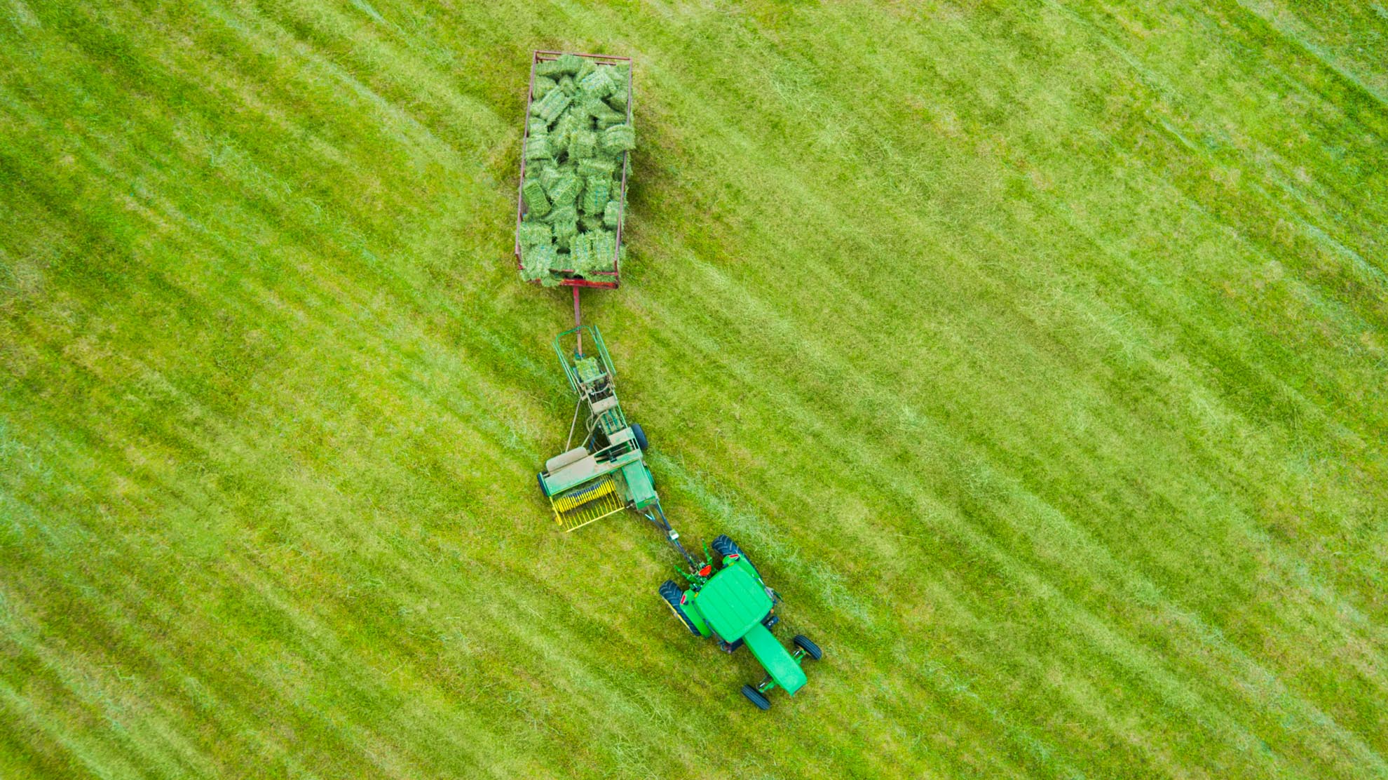 Drone Photograph of birds eye view of farm tractor with hay bails in New Jersey