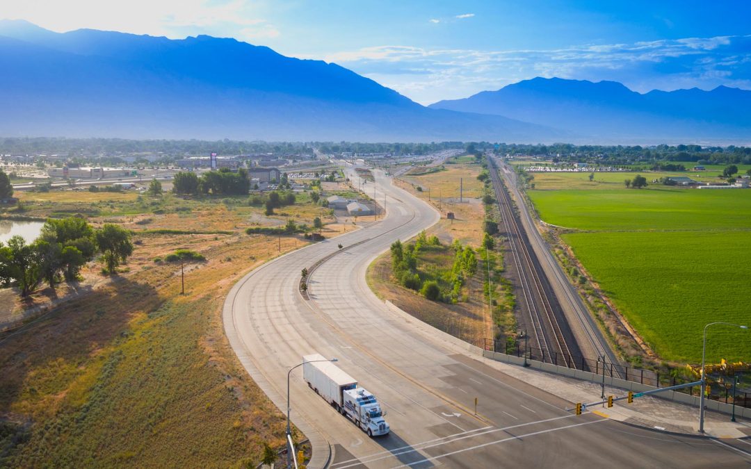 Drone Photograph of Moving truck in the morning with Wasatch Mountains in the background
