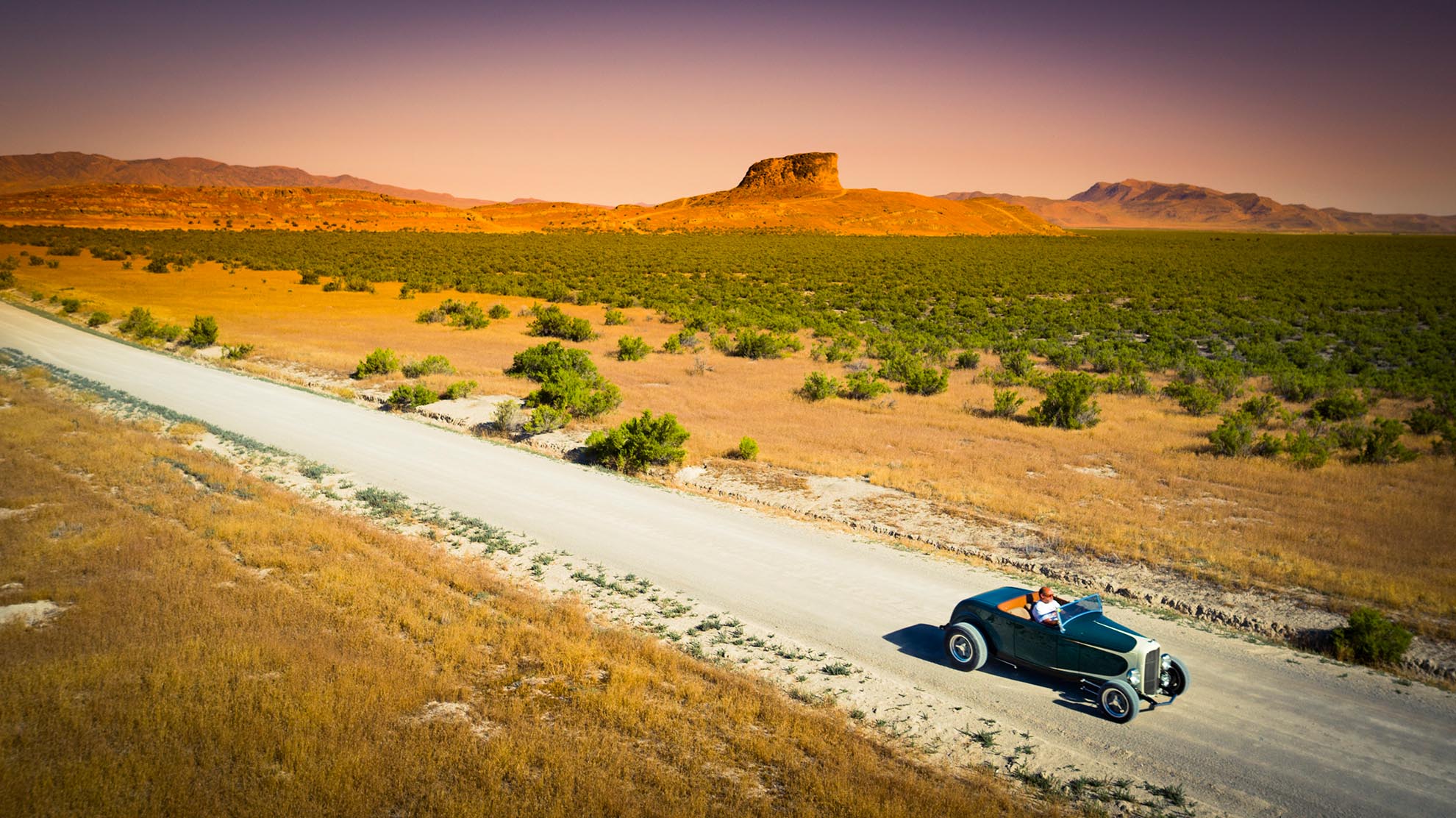 Drone Photograph of Racer Ray in Hot Rod on dirt road in Utah Desert
