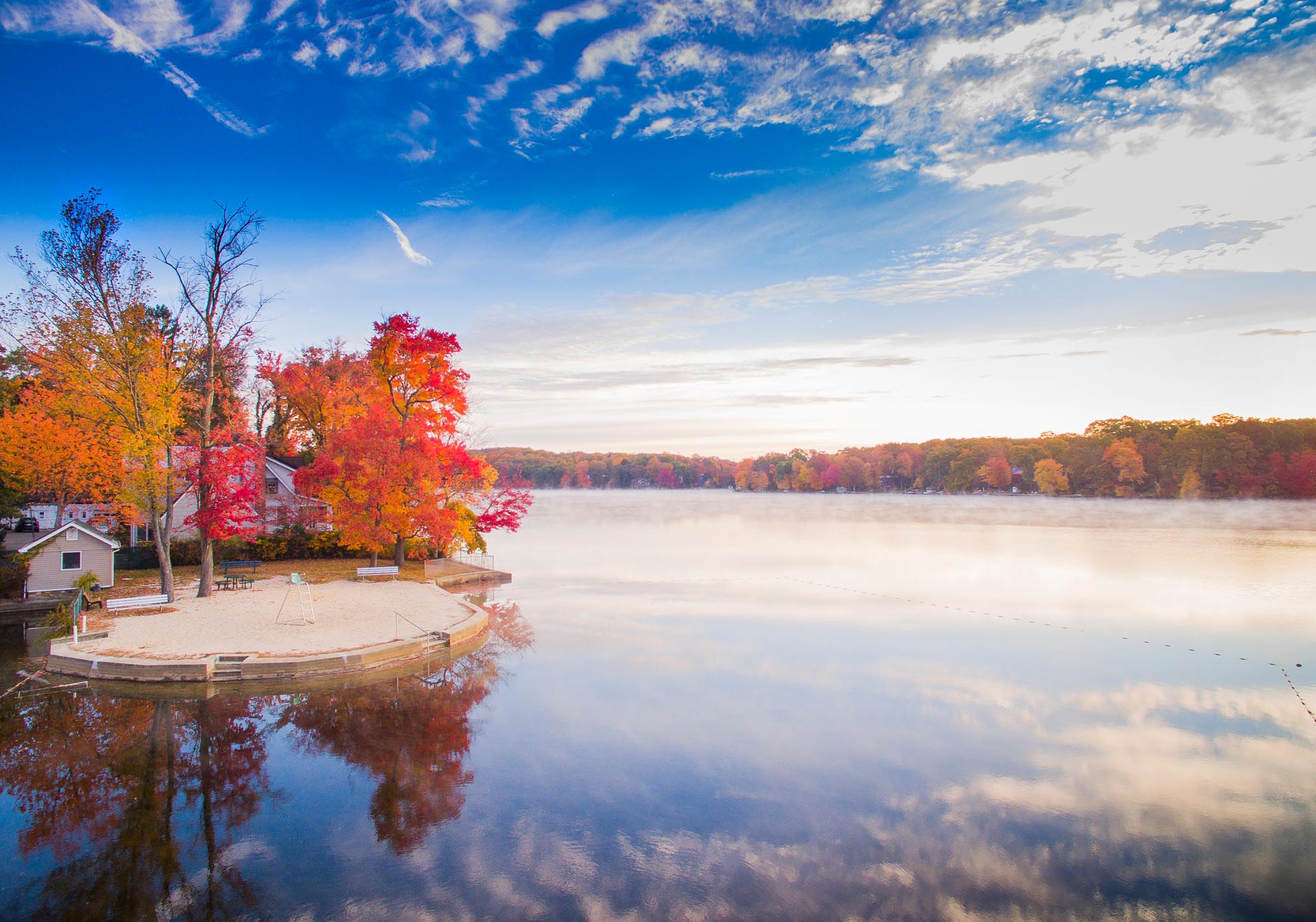 Photograph of Cedar Lake NJ in Autumn with morning fog taken from a drone