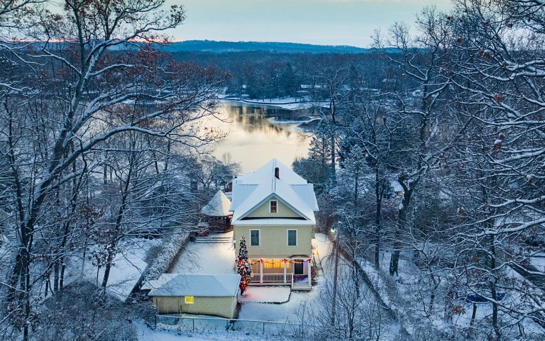 Drone Photograph of Lake Home with Christmas Decorations after snow fall