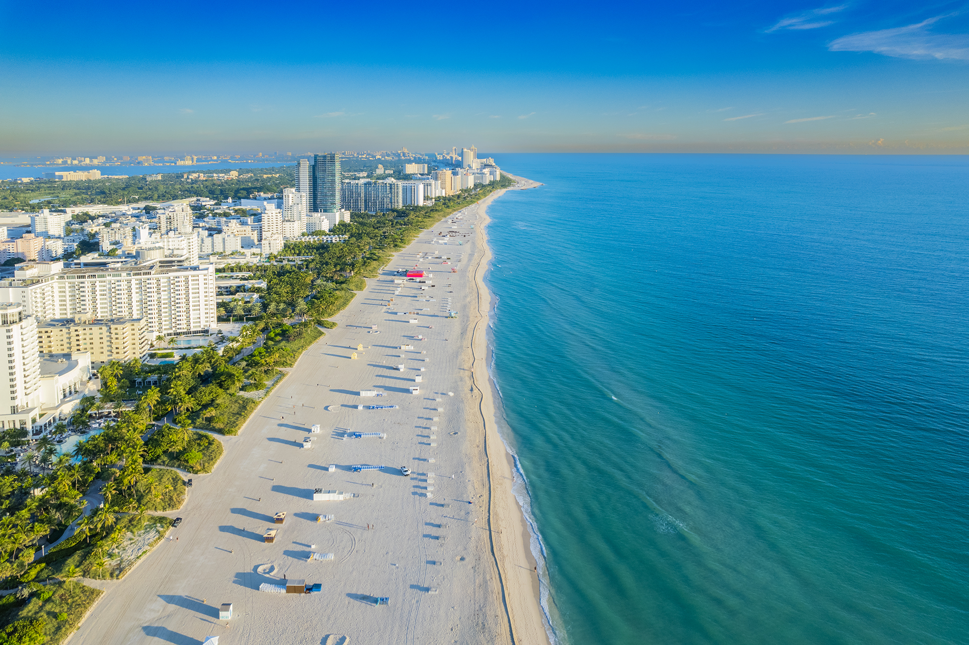 Drone Photograph of Miami Beach from the ocean at sunrise showing the white hotels